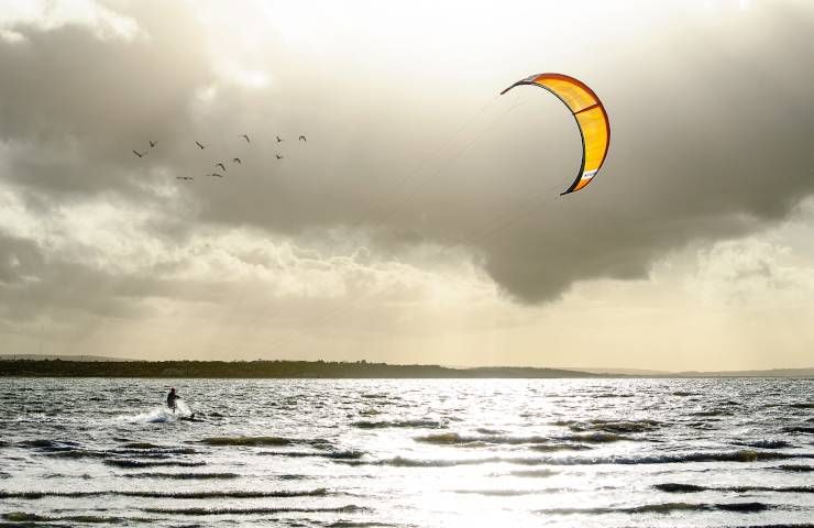 Kitesurfer tempesta estiva forte vento sabbia